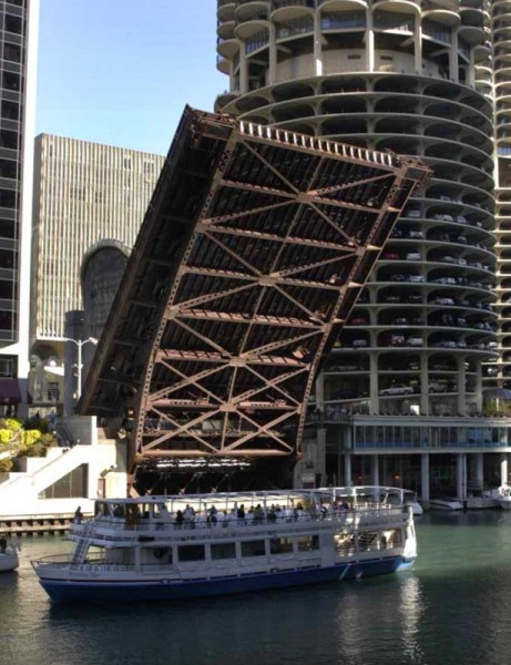 Boats on the Chicago River with lifted bridge