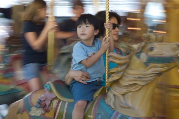 Child riding old fashioned musical carousel at Navy Pier